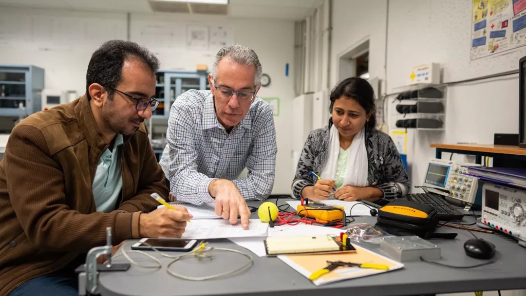 Researchers collaborating at a lab workbench